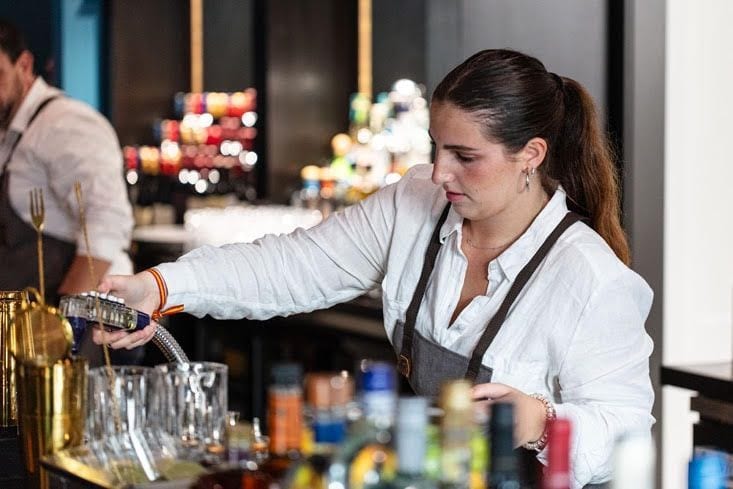 Bartender crafting cocktails at an event