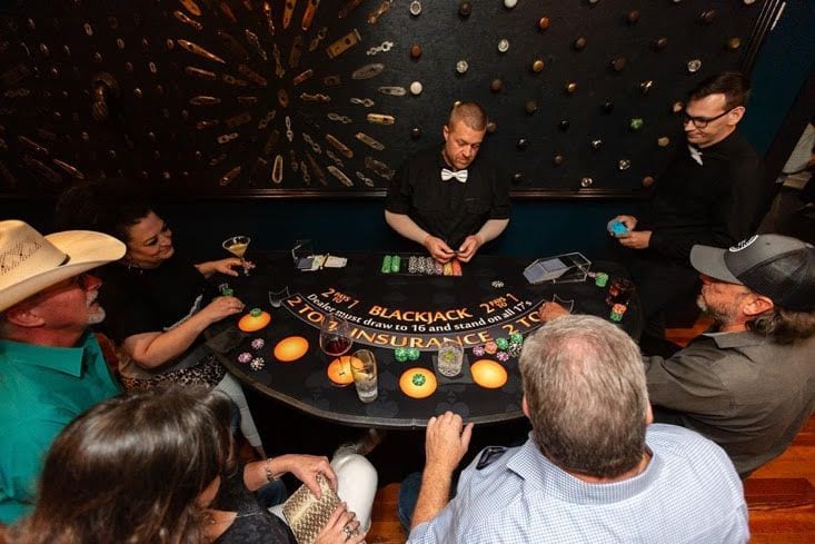 Guests playing blackjack at a WhiskyWoods event