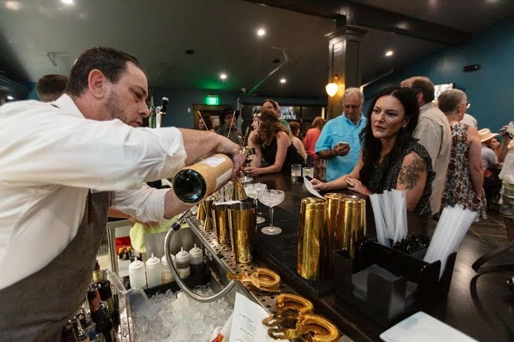 Bartender pouring champagne at a WhiskyWoods event